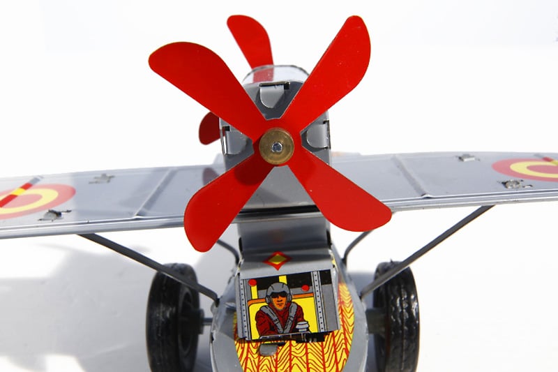 Close up of 2-man propeller plane Tin Toy