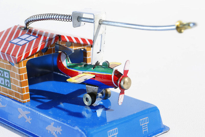 Close up of Aeroplane hangar tin toy
