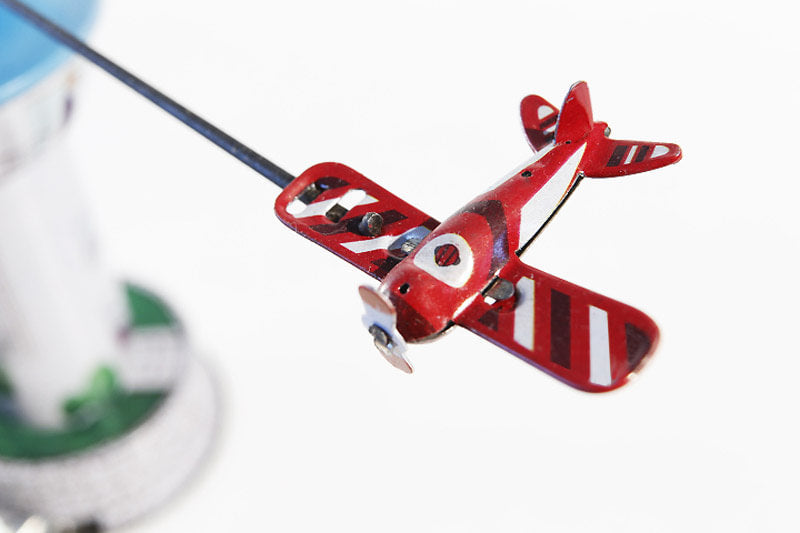 Airport tower carousel tin toy with red plane