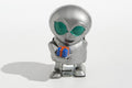 Metallic alien tin toy holding a small gift box