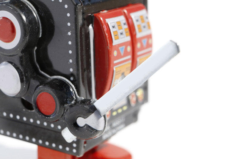 Close up of black robot tin toy with sword