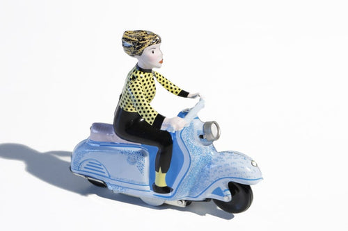 Blue Scooter Girl Tin Toy with blue scooter and woman wearing black trousers and black and yellow polka dot top