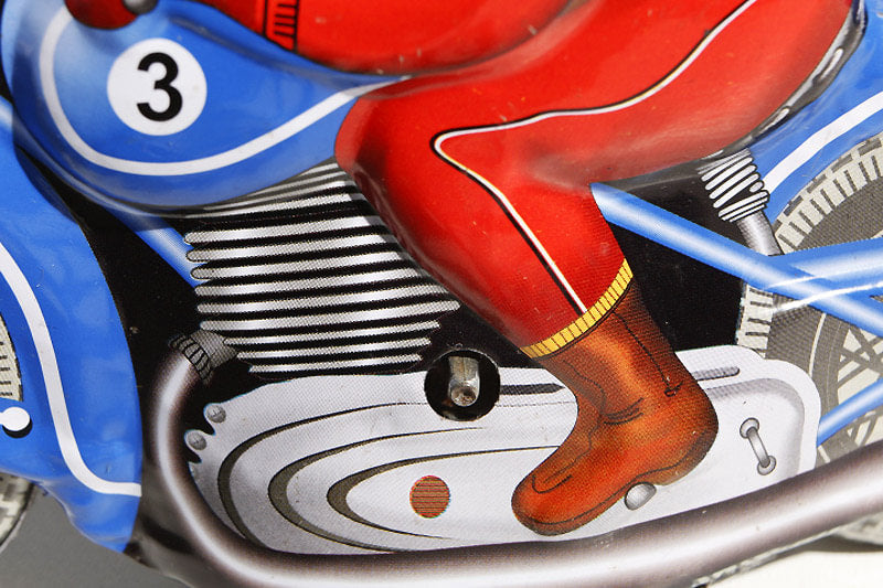 Close up of blue motor racer tin toy
