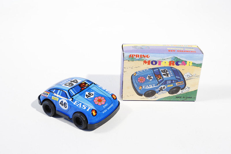Blue race car tin toy with the number 46 and the packaging