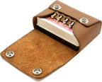 Brown leather cribbage set with cribbage board, pegs and playing cards all within the brown leather pouch.