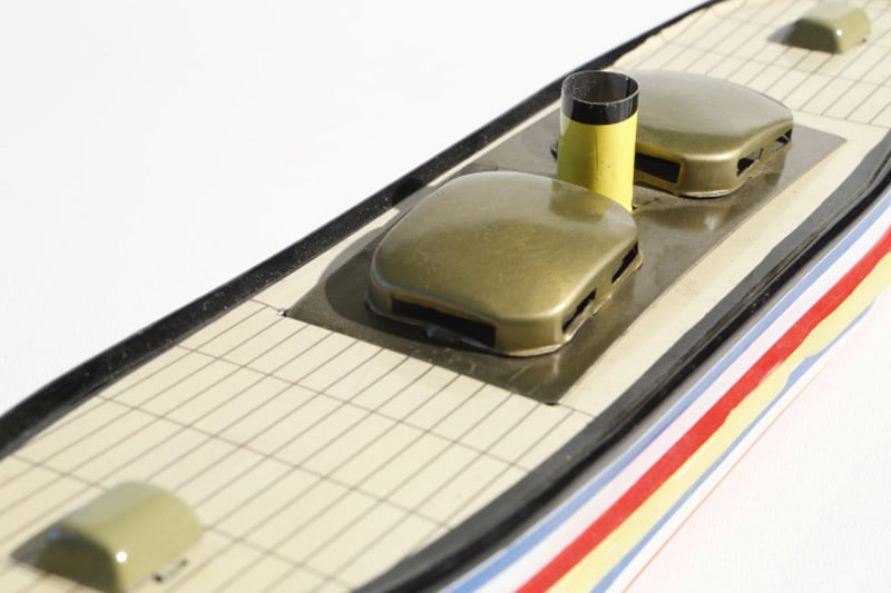 Close up of Canal barge tin toy candle boat 