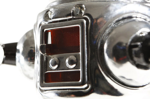 Close up of Chrome sparking Vintage tin toy robot 