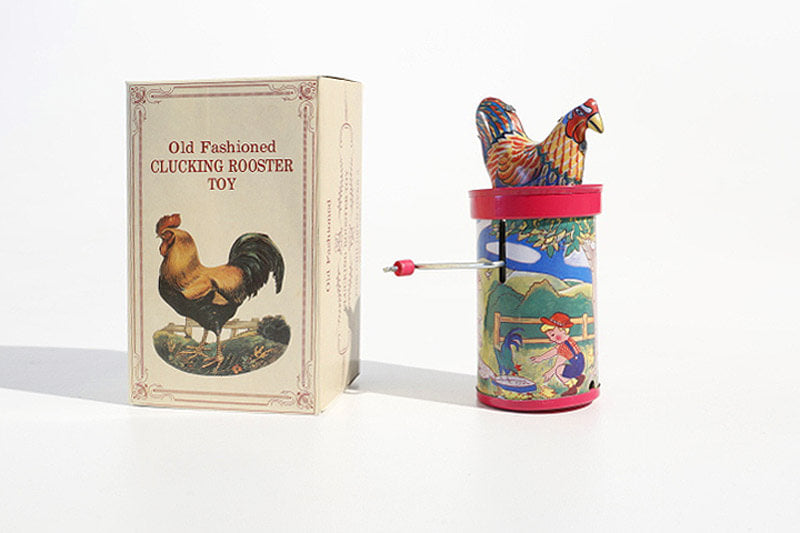 Colourful clucking rooster tin toy with its packaging