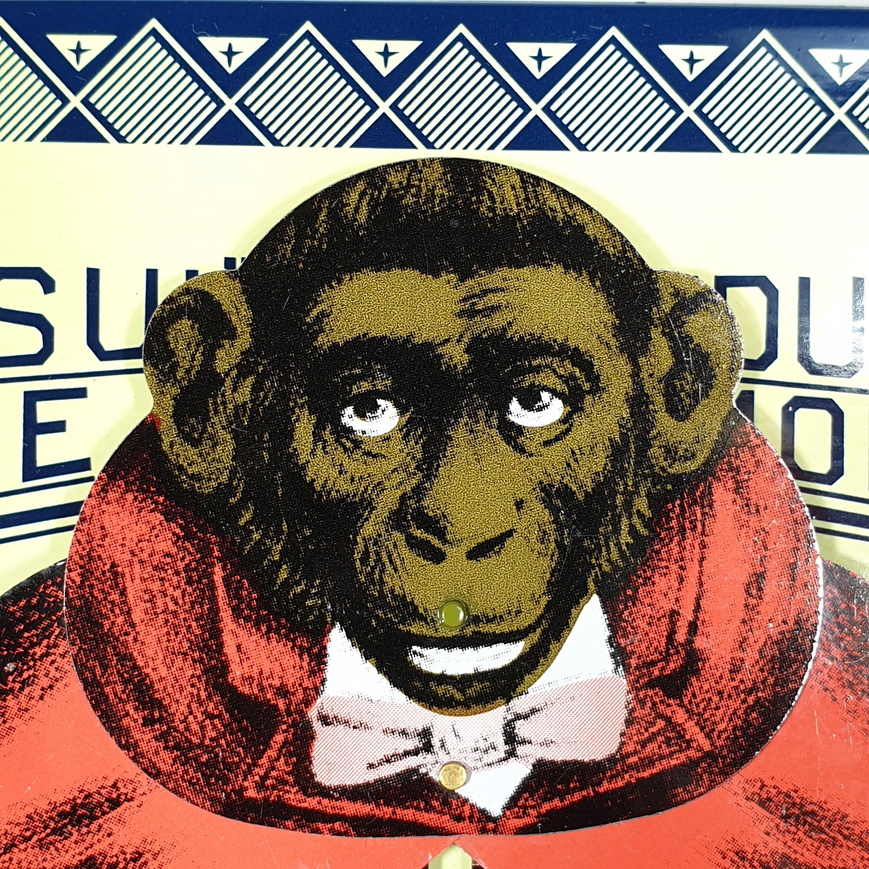 Monkey face from consult the educated monkey tin toy 