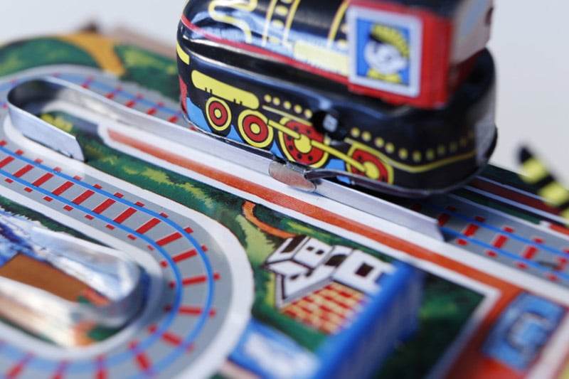 Close up of Cross Road Train With Barriers tin toy with black train