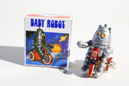 Cycling Tin Toy robot next to packaging 