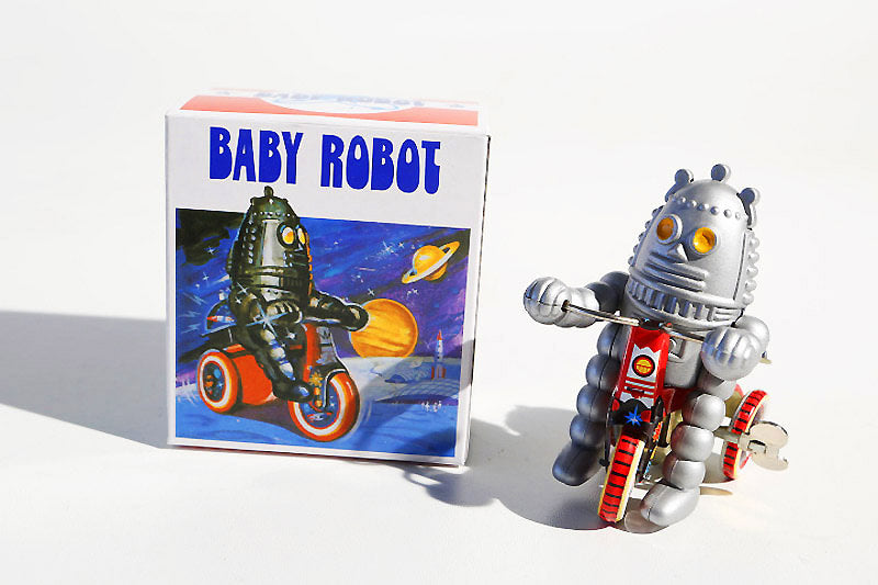Cycling Tin Toy robot next to packaging 