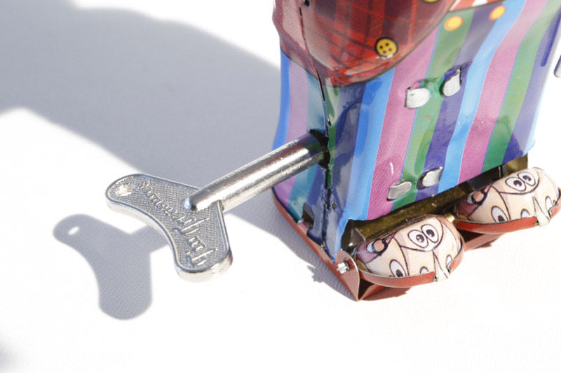 Close up of Dandy Clockwork Clown tin toy wind up key