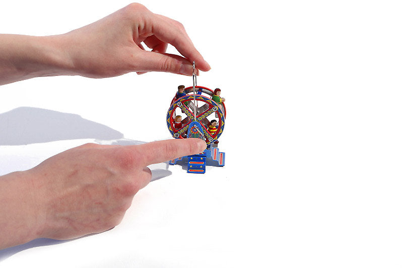 Colourful Ferris wheel Tin Toy held by a hand 