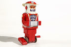 Fireman tin toy robot with a fireman helmet and hose