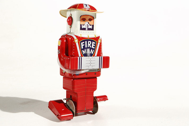 Fireman tin toy robot with a fireman helmet and hose
