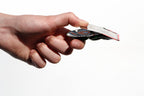 Click clack frog being held in someone's hand