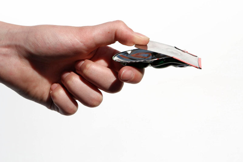 Click clack frog being held in someone's hand