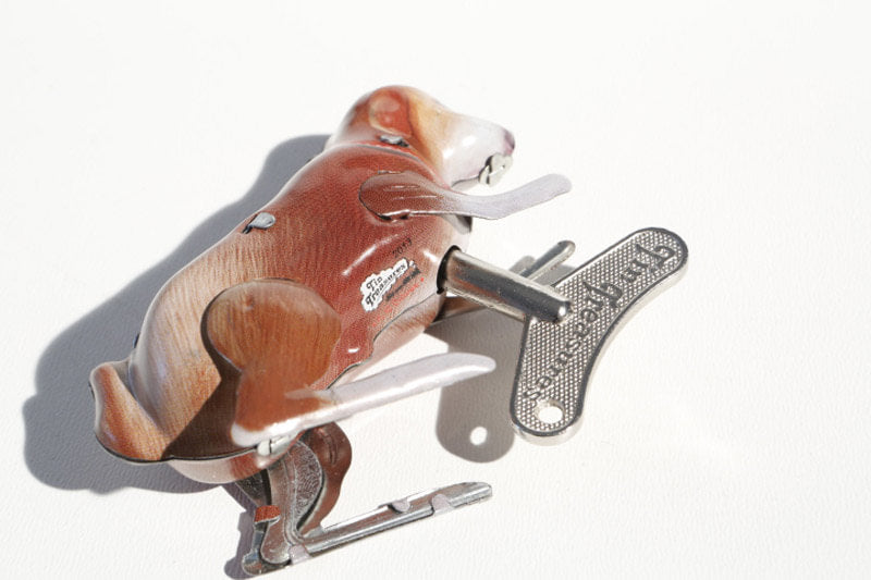 Brown Jumping dog tin toy with wind up key