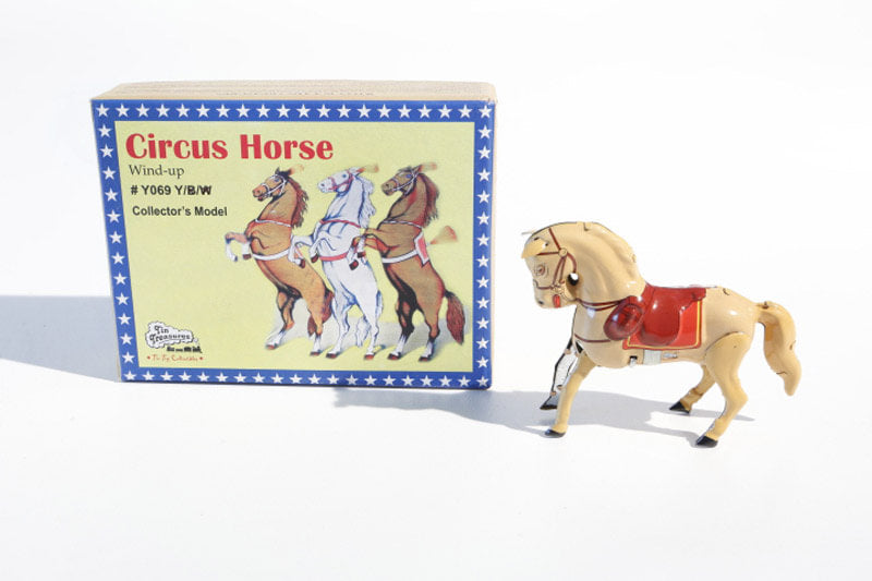 jumping horse tin toy next to its packaging