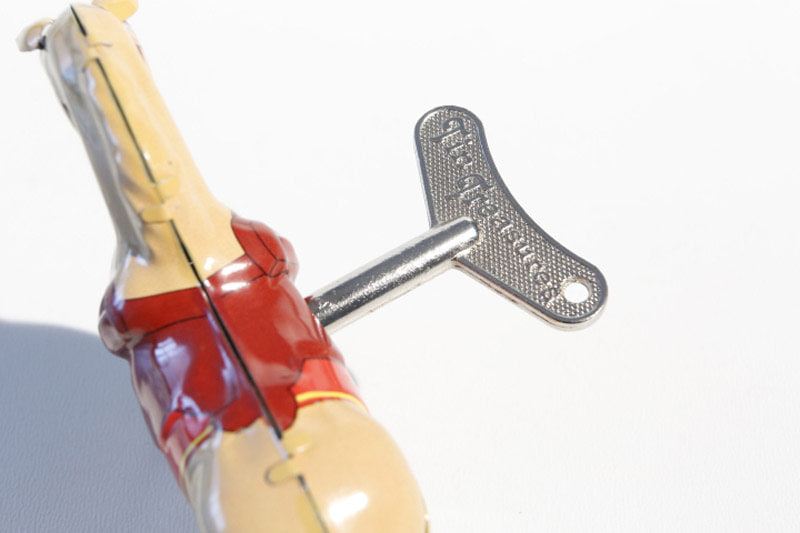 Close up of jumping horse tin toy with wind up key