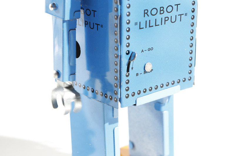 Close up of blue lilliput tin toy robot stop/go lever