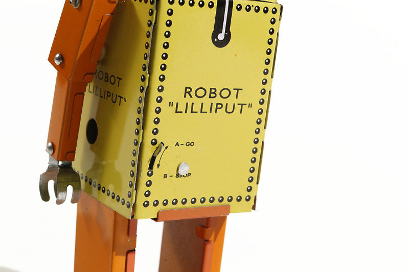 Close up of yellow lilliput tin toy robot stop/go lever
