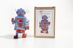 Little Drumming Vintage-style robot tin toy with blue and red colours with packaging