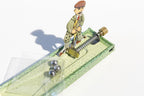 Close up of Little golfer tin toy with golfer and balls
