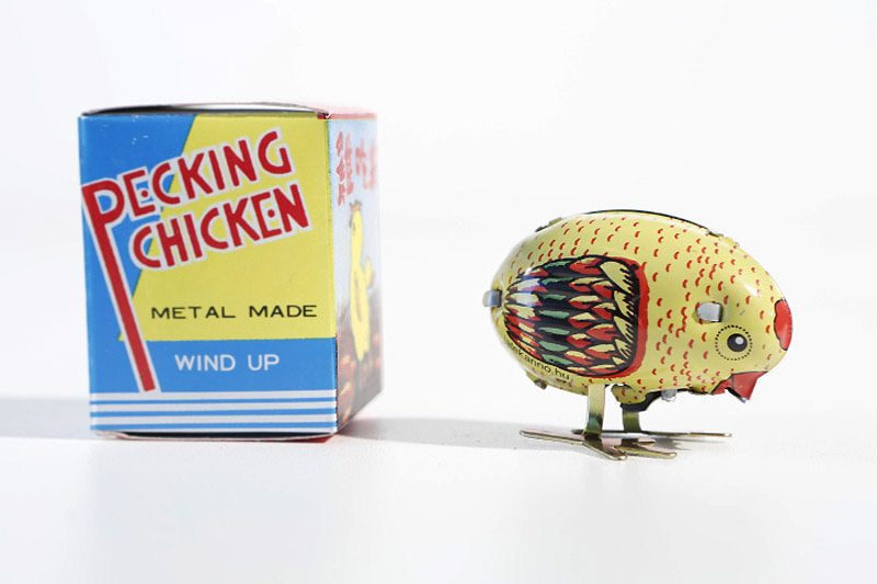 Colourful pecking chicken tin toy with its packaging