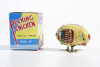 Colourful pecking chicken tin toy with its packaging