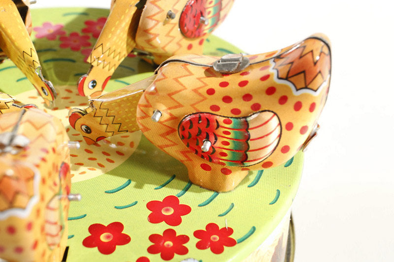Close up of pecking chickens tin toy