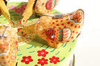 Close up of pecking chickens tin toy