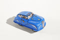 Blue police car tin toy with cartoon characters inside 