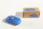 Blue police car tin toy with packaging