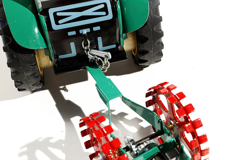 Close up of Potato Harvester tin toy