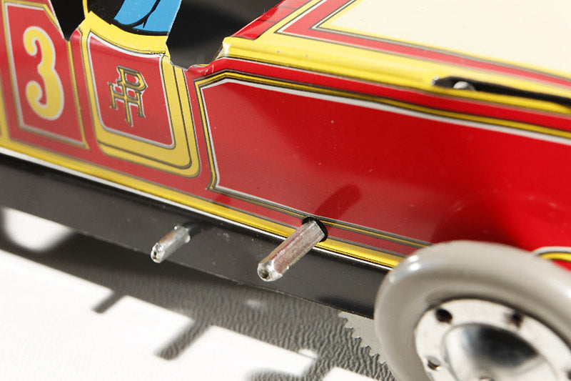 Close up of Red Race Car number 3 tin toy