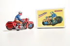 Red motorcycle tin toy with colourful packaging 