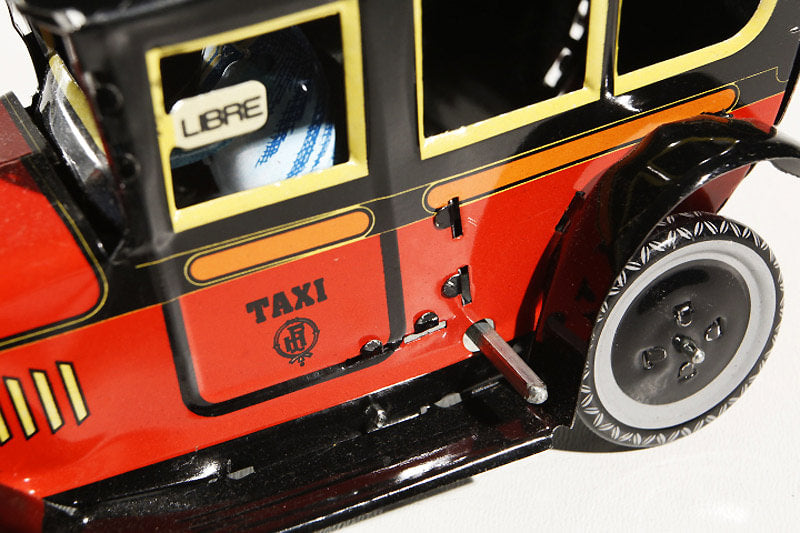 Close up of Red Taxi Tin Toy