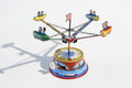 Small Rocket carousel tin toy with lever