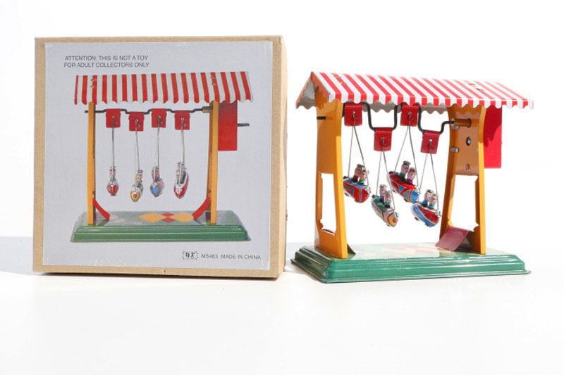 Small swing boats fairground tin toy with packaging