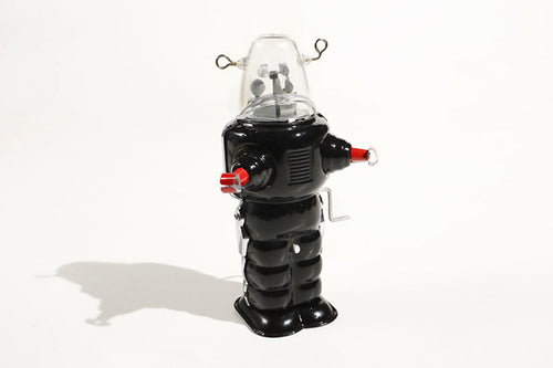 Black robot space trooper tin toy with clear dome and red accents