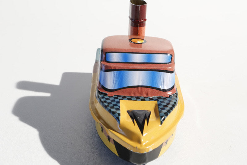 Close up of Tin Treasure's Pop Pop Speed Boat tin toy
