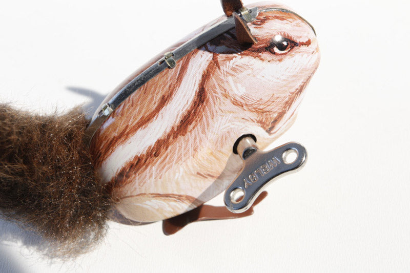 Close up of squirrel tin toy with wind up key