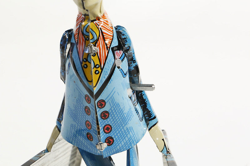 Close up of Paya imitation Student with suitcase tin toy