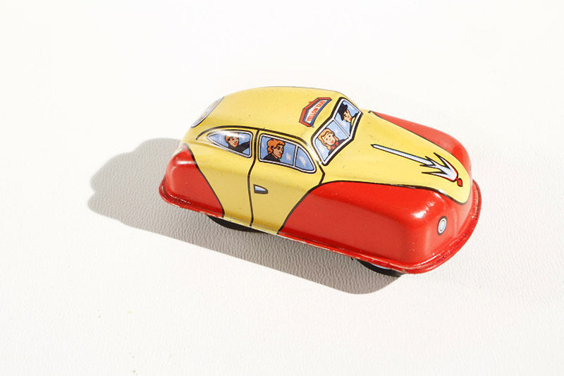 Taxi tin toy car with a yellow and red body