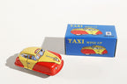 Taxi tin toy car with a yellow and red body with packaging