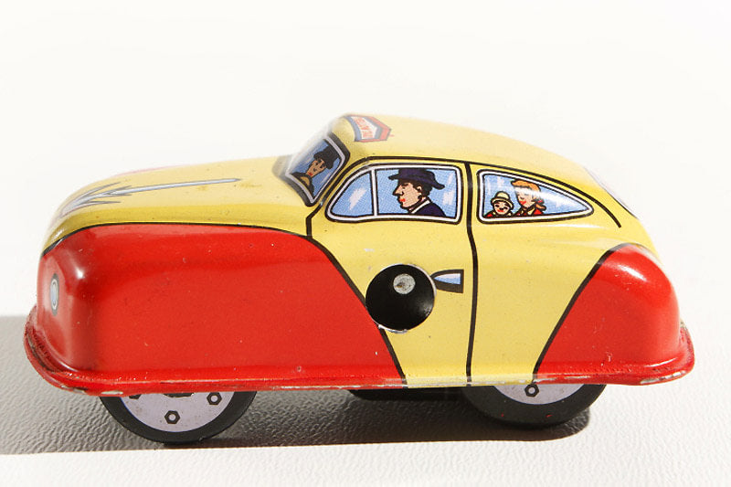 Taxi tin toy car with a yellow and red body