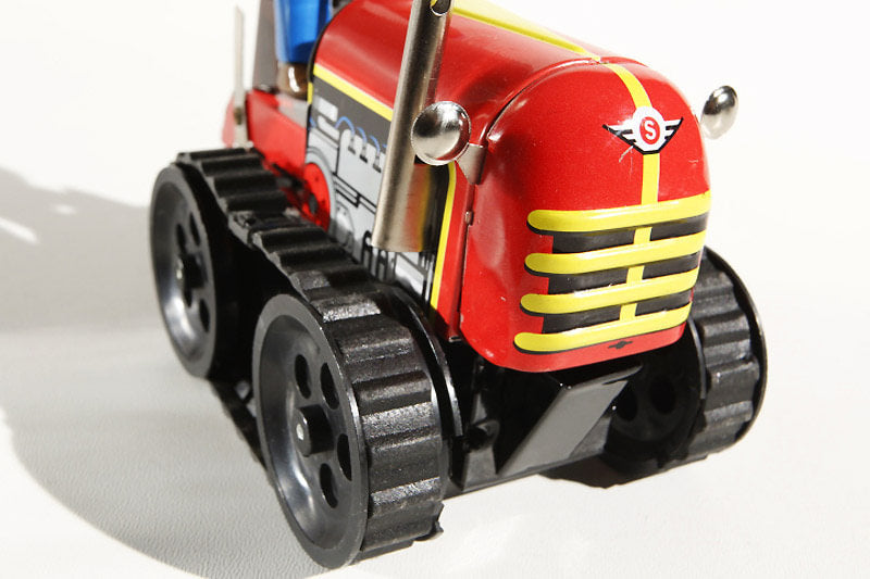 Close u of Caterpillar tractor tin toy