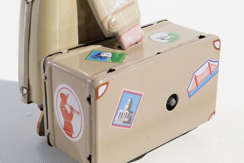 Close up of Trade Fair Man tin toy suitcase